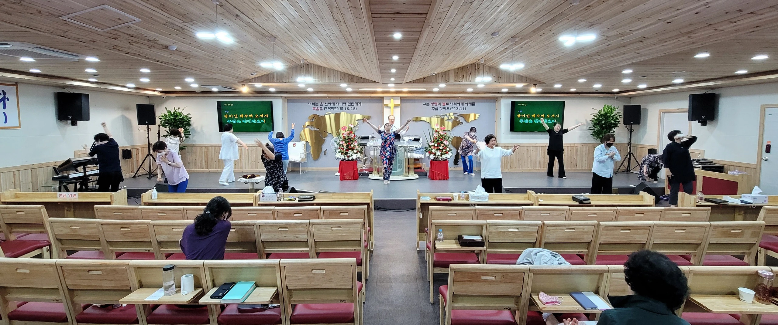 The Reverand Doctor (Pastor) Yong Doo Kim is leading church from behind the pulpit, while his wife & the women are exhaulting (glorifying & worshiping) The Lord through dancing. The Reverand Doctor (Pastor) Yong Doo Kim is leading church from behind the pulpit, while his wife & the women are exhaulting (glorifying & worshiping) The Lord through dancing.